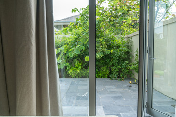 Open window in tropical villa. Summer garden, view outdoor
