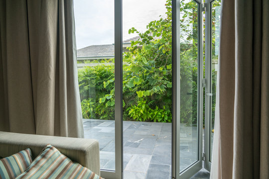 Fototapeta Open window in tropical villa. Summer garden, view outdoor
