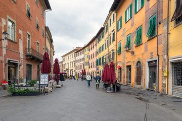 PISA, ITALY - OCTOBER 29, 2018: old streets of the center of Pisa with its characteristic ocher color - obrazy, fototapety, plakaty