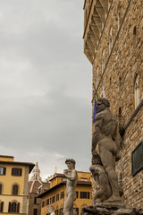 Fototapeta na wymiar FLORENCE, ITALY - OCTOBER 28, 2018: The Palazzo Vecchio is the town hall of Florence, Italy. It overlooks the Piazza della Signoria with its copy of Michelangelo's David statue 