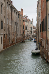 Obraz na płótnie Canvas VENICE, ITALY- OCTOBER 30, 2018: Traditional narrow canal with gondolas in Venice, Italy
