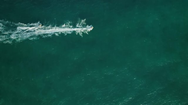 Aerial view above two jet ski sailing straight in lake in Sharjah, U.A.E.