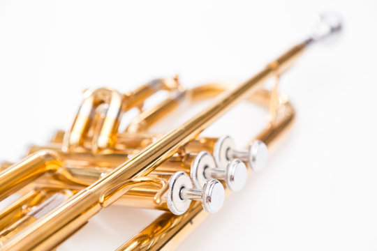 Close up of trumpet on white background. Detail of old trumpet instrument.