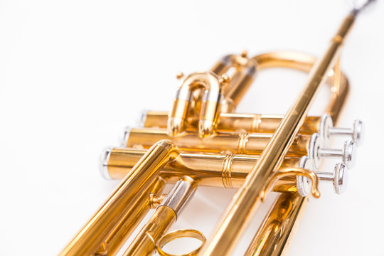 Close up of trumpet on white background. Detail of old trumpet instrument.