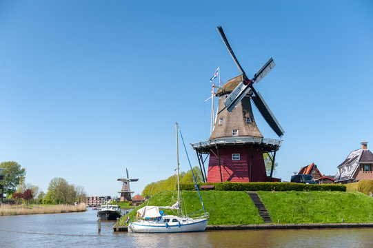 A Classic Dutch Windmill in the city of Dokkum, Friesland, in the Northern parts of the Netherlands, as seen on a bright sunny spring afternoon