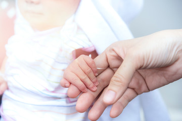 newborn putting hands together with hands mommy. Concept of love and family