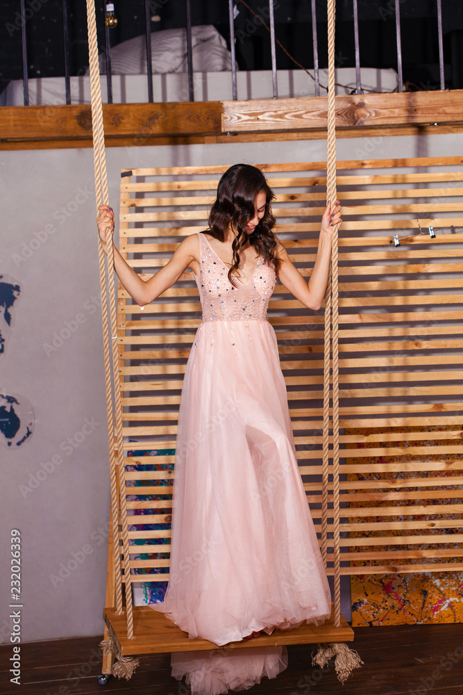 Canvas Prints high fashion shot of young brunette woman in pink long dress