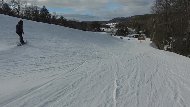 Female freestyle skiier grinds over rainbox rail