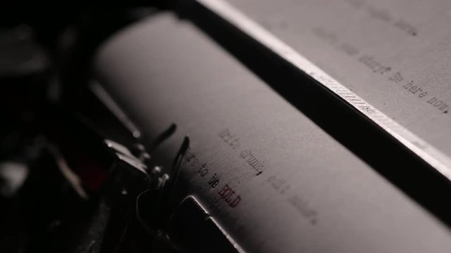 Dare to be bold, fast rack focus shot of words typed out on old typewriter