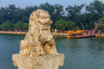 Fototapeta na wymiar Lion sculpture the famous 17 arch lion bridge on Kunming Lake outside of Summer Palace in Beijing, China