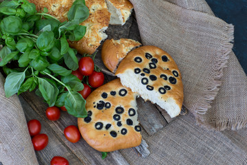 on a wooden table bread, tomatoes and basil