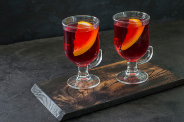 hot red drink in transparent mugs - hot wine, mulled wine, grog, tea with orange