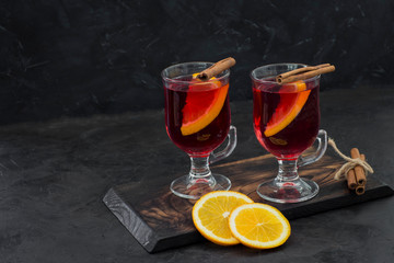 hot red drink in transparent circles with cinnamon and orange - hot wine, mulled wine, grog, tea...