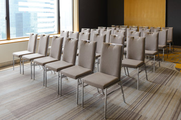 Rows of chairs near window in the conference hall