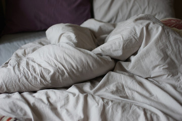 Crumpled bedding on the bed