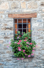 Facade of ancient house decorated with flowers
