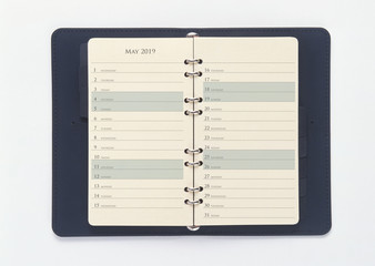 May 2019 calendar in the blue organizer book, isolated on white background with clipping path. 