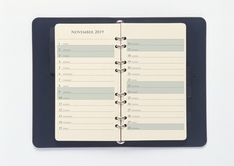 November 2019 calendar in the blue organizer book, isolated on white background with clipping path. 