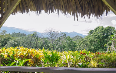 View from traditional gazebo roofed in palm tree mountains to enjoy the fresh breeze and landscape