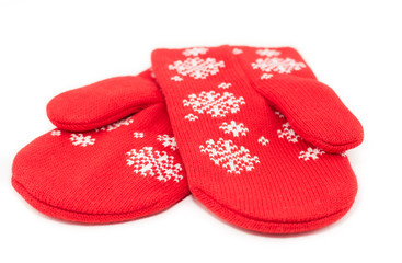 Christmas red knitted mittens with snowflake motives on white background. Pair of red woolen gloves, isolate on white  