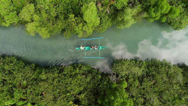 Aerial view of traditional fishing boat sailing in Bojo River, Aloguinsan, Philippines.