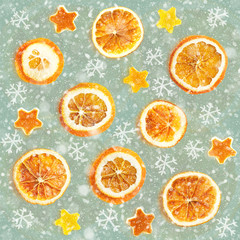 Christmas background of dried oranges, orange peel in the shape of a star. Seamless background