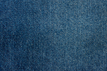 Naklejka premium Texture of blue denim without seams and buttons close-up shot.