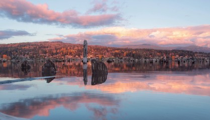 Beautiful reflection  over pacific northwest lake at sunset with cloudy sky