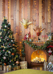 Christmas and New Year decorated the interior wooden room with gifts and a Christmas tree with a fireplace and carnival masks.