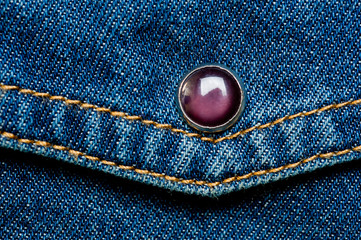 Textured blue denim texture stitched with a buttoned texture