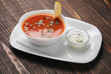 Ukrainean red soup with sour cream and lemon