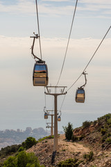 cable car in the mountains against the background of the city