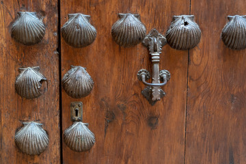 old wooden door decorated with shells