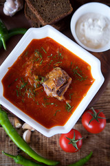 Delicious rich borscht with beef is on the table in the restaurant.