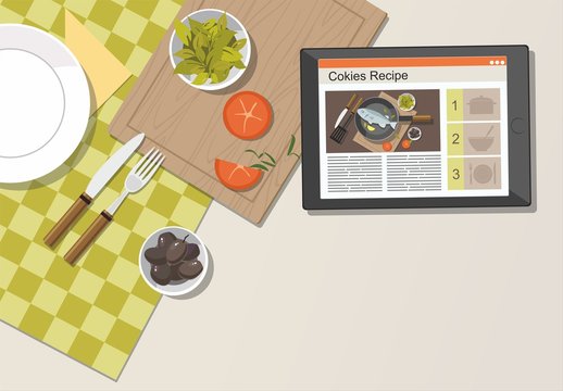 Digital tablet in kitchen with fresh herbs, tomatoes. Recipe on website 