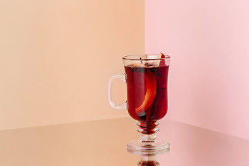 Mulled wine in glass on the glass table. Winter concept