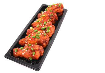 Korean fried chicken with white backdrop.