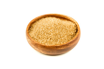 Scoop of raw cane sugar isolated over white