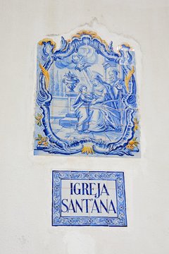 Traditional Portuguese blue and gold ceramic religious picture on the wall of St Annes church (Igreja de Sant Ana), Albufeira, Portugal.