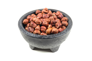 Pile of whole unshelled hazelnuts isolated