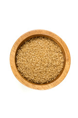 Scoop of raw cane sugar isolated over white
