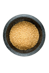 Scoop of raw cane sugar isolated over white
