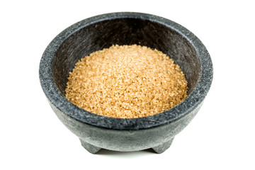 Scoop of raw cane sugar isolated over white