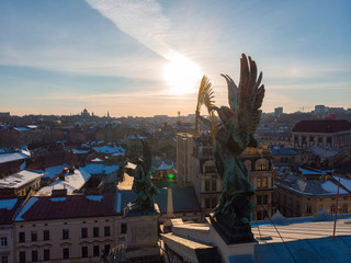 statue on roof of old european building on sunset