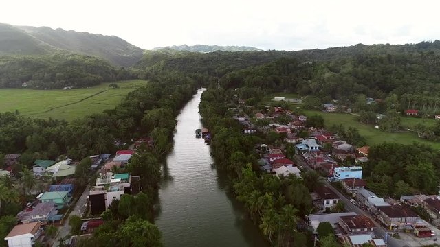 Aerial view of river crossing the city of Loboc, Philippines.