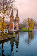 Evening view of the canal and the VVE Oostpoort de Delft. Dutch city in the spring after sunset. Holland, Netherlands.