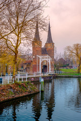 Obraz premium Evening view of the canal and the VVE Oostpoort de Delft. Dutch city in the spring after sunset. Holland, Netherlands.