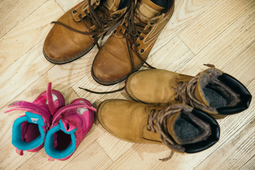 father, mother and daughter shoes. overhead view