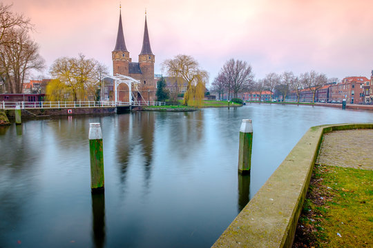 Evening view of the canal and the VVE Oostpoort de Delft. Dutch city in the spring after sunset. Holland, Netherlands.