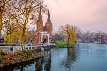 Evening view of the canal and the VVE Oostpoort de Delft. Dutch city in the spring after sunset. Holland, Netherlands.